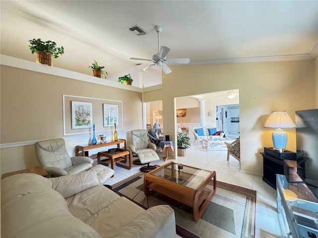 living area featuring visible vents, ornamental molding, light tile patterned floors, lofted ceiling, and ceiling fan