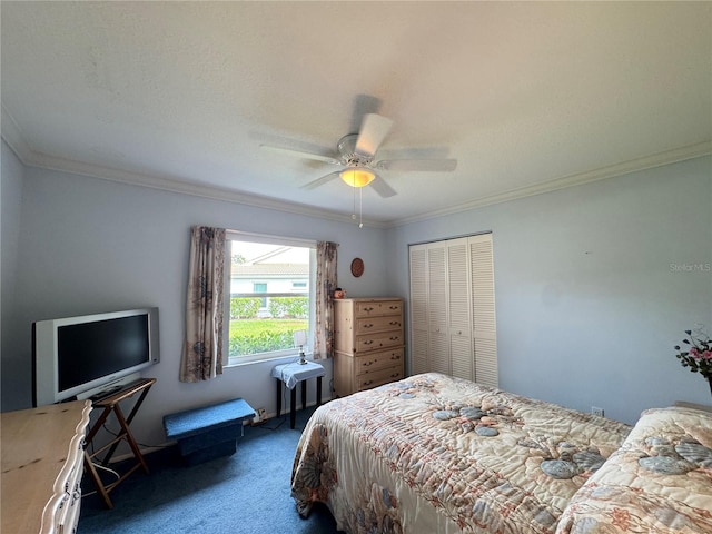 carpeted bedroom featuring a closet, ceiling fan, and crown molding