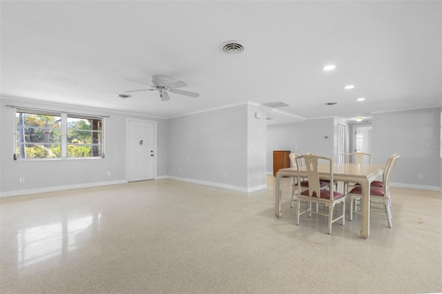 dining space featuring visible vents, ornamental molding, a ceiling fan, light speckled floor, and baseboards