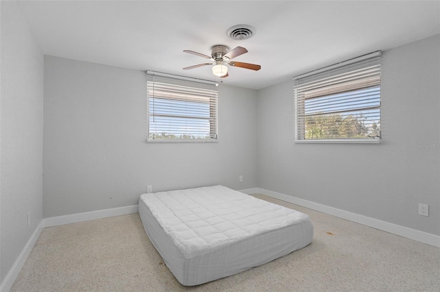 bedroom featuring baseboards, visible vents, and ceiling fan