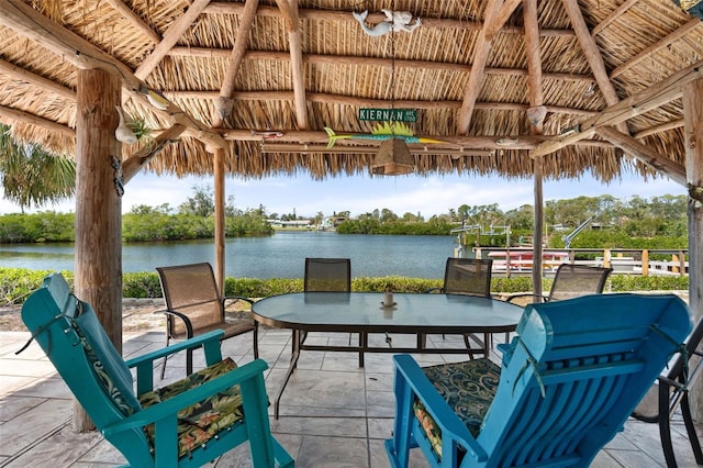 view of patio featuring a gazebo and a water view