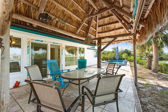 view of patio / terrace featuring an outdoor pool, outdoor dining area, and a gazebo