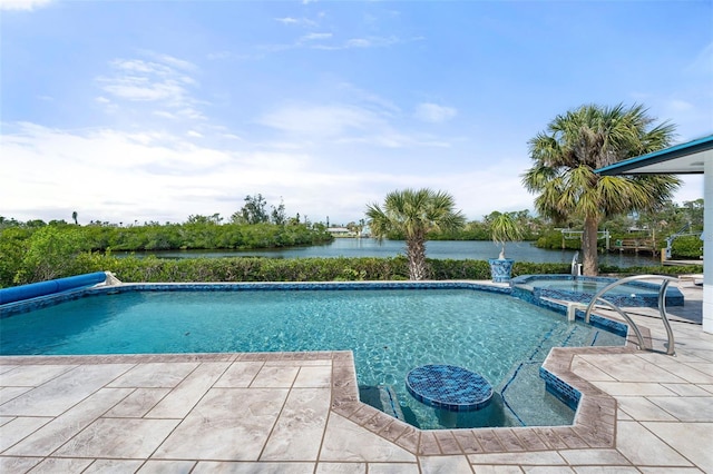 view of pool featuring a pool with connected hot tub, a patio, and a water view