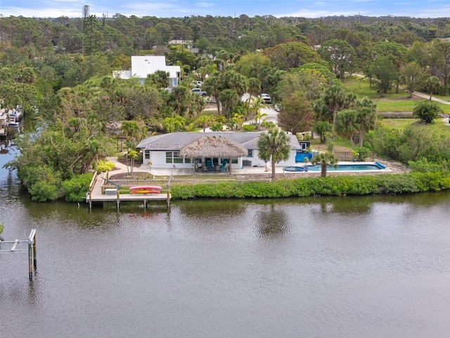 aerial view featuring a water view and a wooded view