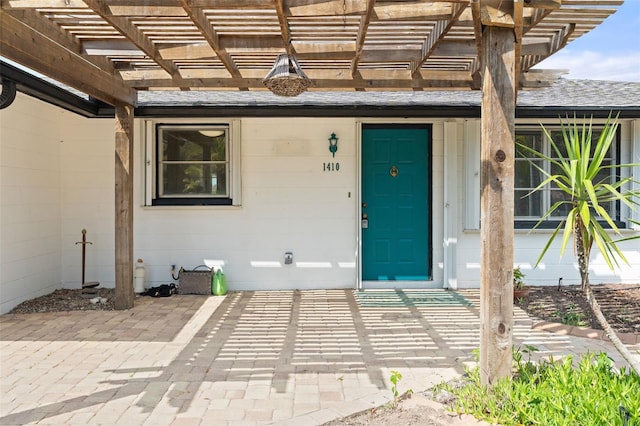 property entrance featuring a pergola