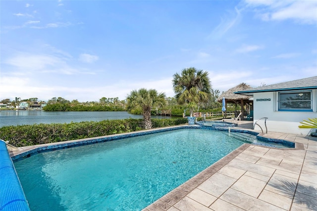 view of swimming pool with a pool with connected hot tub, a patio, and a water view