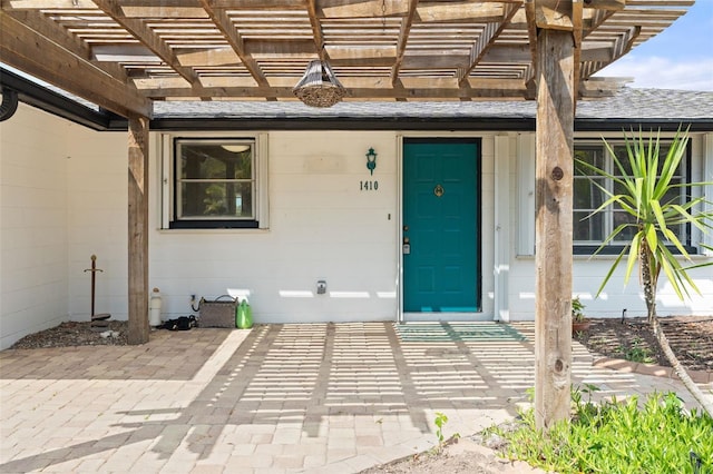 doorway to property with a pergola