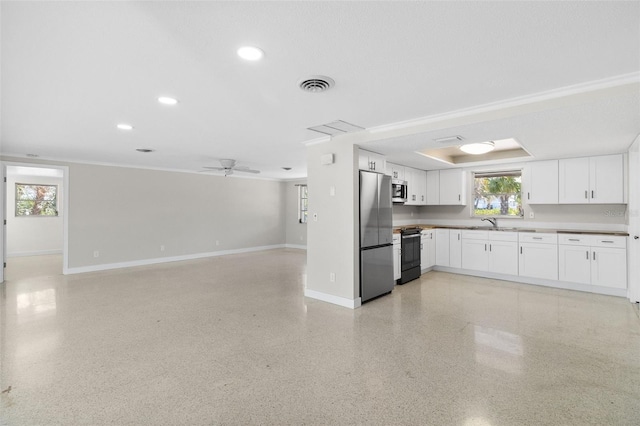 kitchen featuring open floor plan, white cabinets, baseboards, appliances with stainless steel finishes, and visible vents