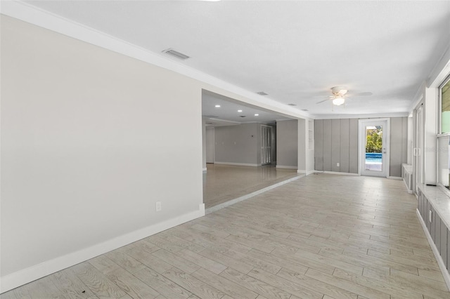 spare room featuring light wood-style floors, visible vents, baseboards, and ceiling fan