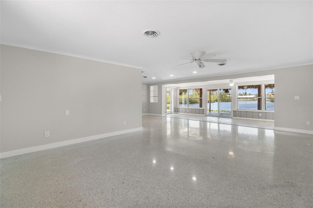 unfurnished room featuring ceiling fan, baseboards, ornamental molding, and visible vents