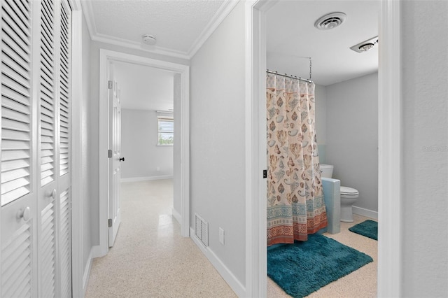 interior space with visible vents, baseboards, and ornamental molding