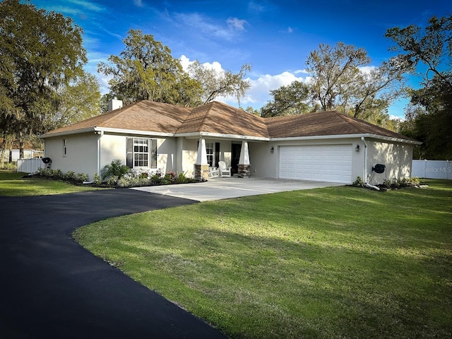 view of front of home featuring stucco siding, driveway, and a garage