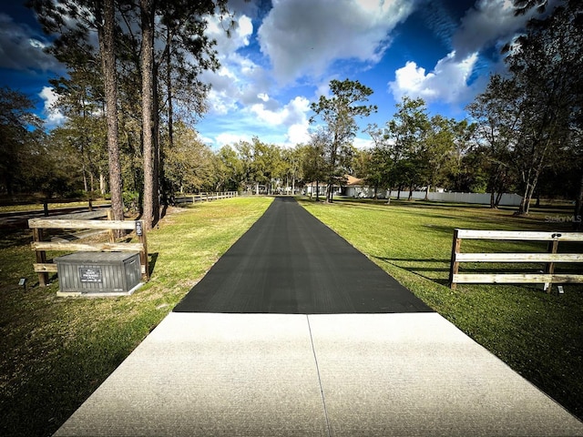 surrounding community featuring a yard and fence