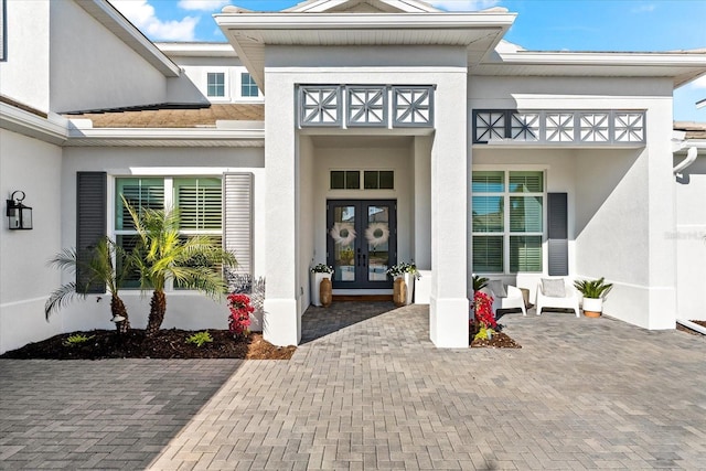 property entrance with french doors and stucco siding