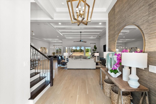 corridor with beam ceiling, stairs, an inviting chandelier, and wood finished floors