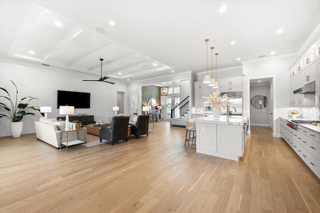 interior space featuring light wood-type flooring, ornamental molding, recessed lighting, stairway, and ceiling fan