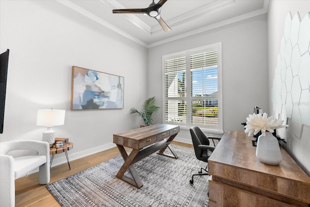 office area featuring ceiling fan, a raised ceiling, wood finished floors, and ornamental molding