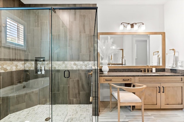 bathroom with a shower stall and vanity