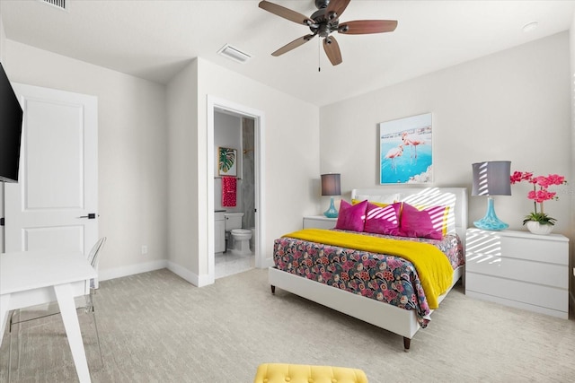 carpeted bedroom featuring visible vents, baseboards, connected bathroom, and a ceiling fan