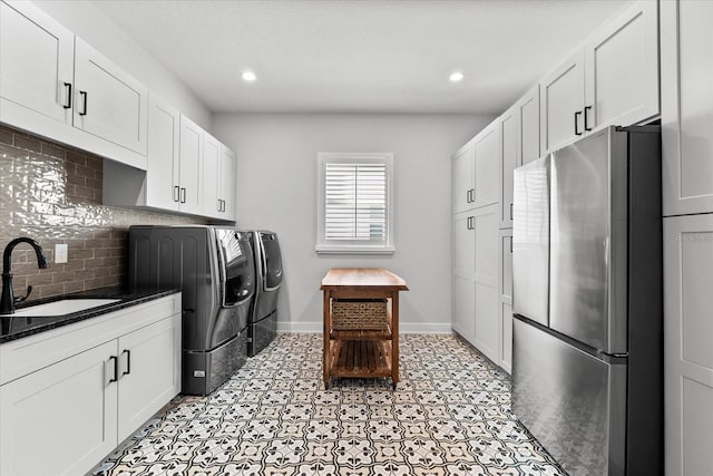 laundry area with washer and clothes dryer, recessed lighting, baseboards, and a sink