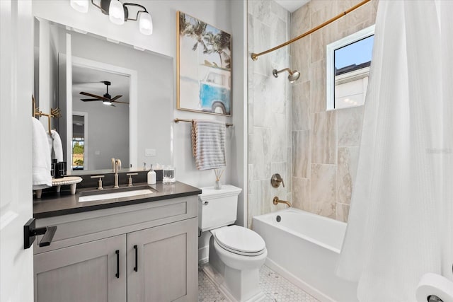 full bath featuring toilet, vanity, a ceiling fan, and shower / bath combo