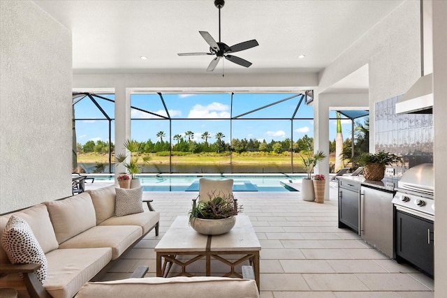 exterior space with an outdoor living space, glass enclosure, an outdoor kitchen, and grilling area