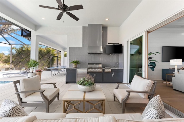 view of patio / terrace featuring an outdoor living space, ceiling fan, glass enclosure, area for grilling, and an outdoor kitchen