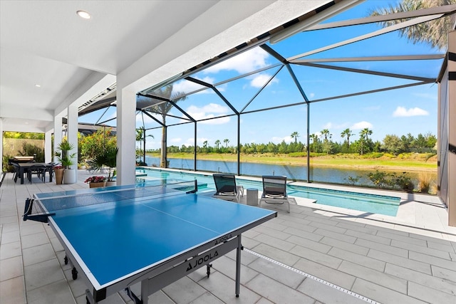 view of patio featuring a lanai, outdoor dining space, an outdoor pool, and a water view