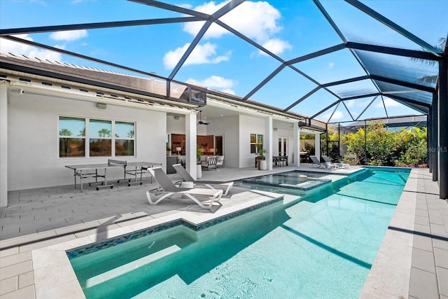 view of pool with a patio, a ceiling fan, a pool with connected hot tub, and a lanai