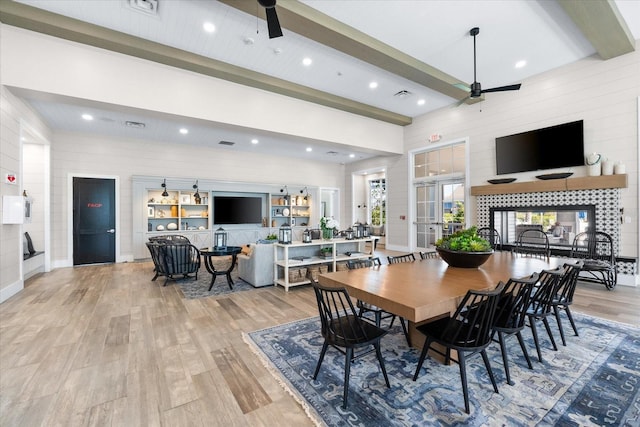 dining room with beamed ceiling, wood finished floors, and ceiling fan