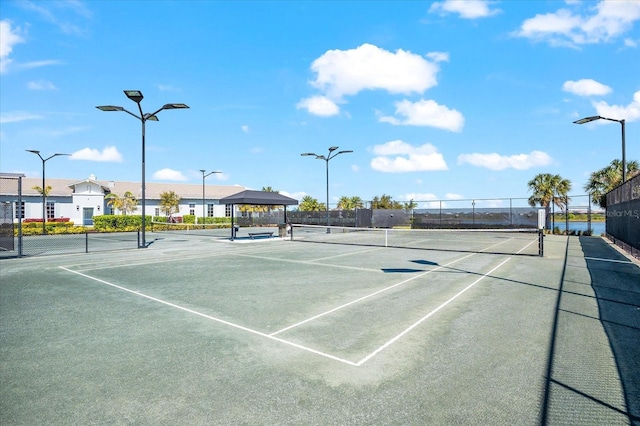 view of tennis court featuring fence