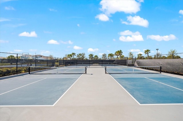 view of tennis court featuring fence