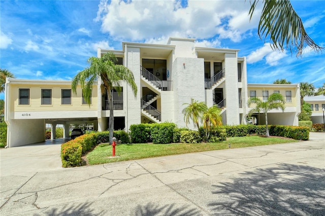 view of building exterior with a carport and driveway