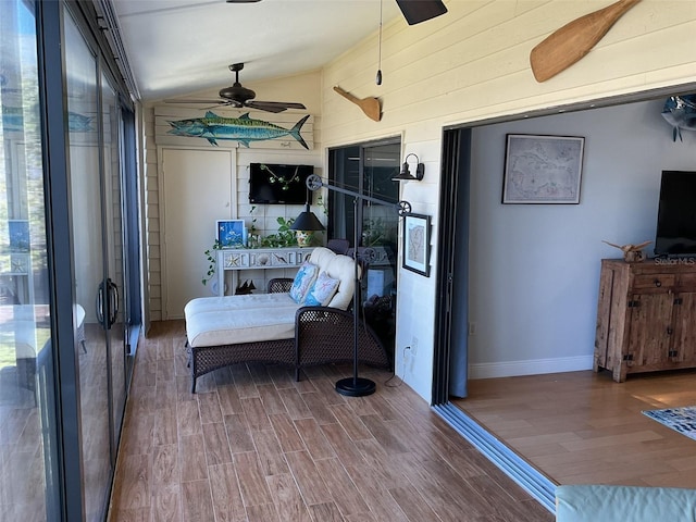 sunroom / solarium with lofted ceiling and ceiling fan