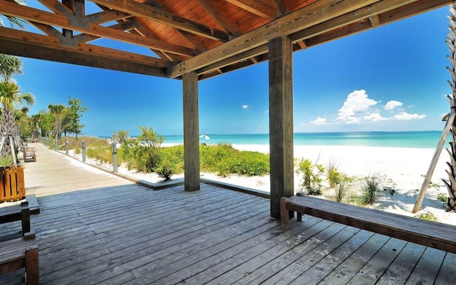 deck featuring a water view and a beach view