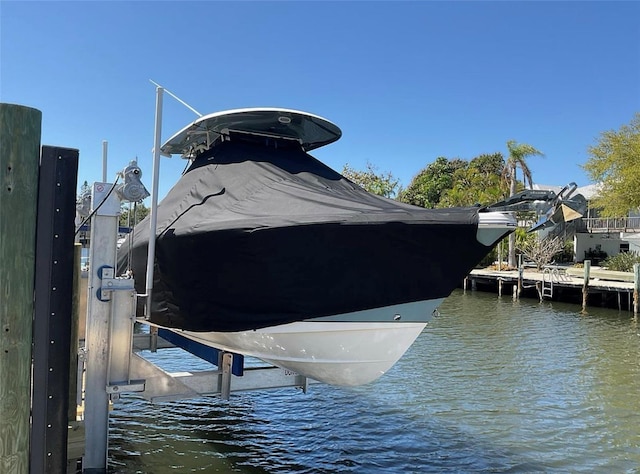 view of dock featuring boat lift and a water view