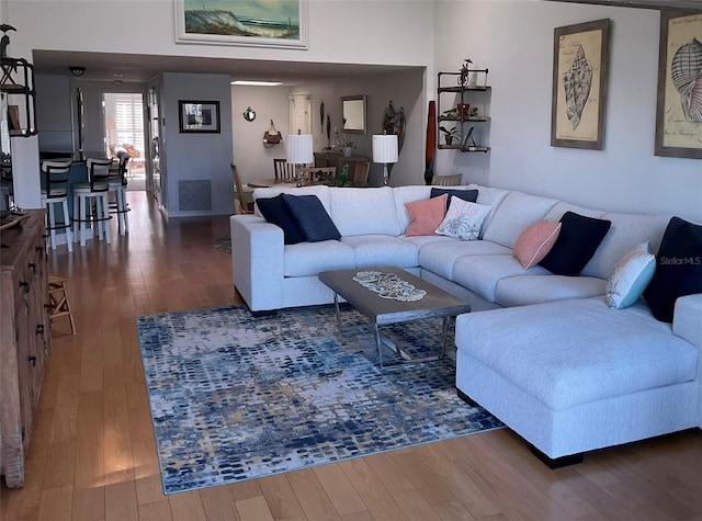 living area featuring hardwood / wood-style floors and visible vents