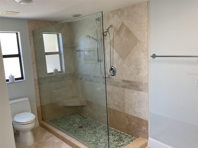 full bath featuring tile patterned floors, visible vents, toilet, and a walk in shower