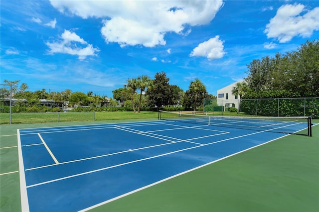 view of tennis court with fence