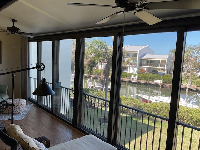 sunroom / solarium featuring a water view