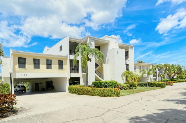 view of property featuring a carport and concrete driveway