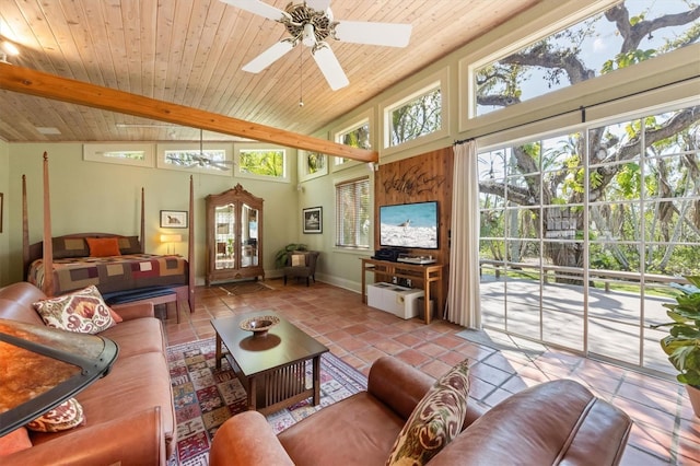 interior space featuring tile patterned flooring, plenty of natural light, a ceiling fan, and beam ceiling