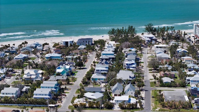 birds eye view of property featuring a view of the beach, a residential view, and a water view