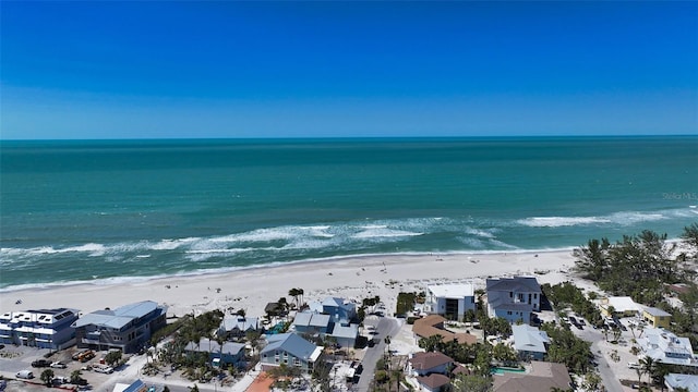 birds eye view of property with a water view and a beach view