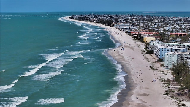 drone / aerial view featuring a beach view and a water view