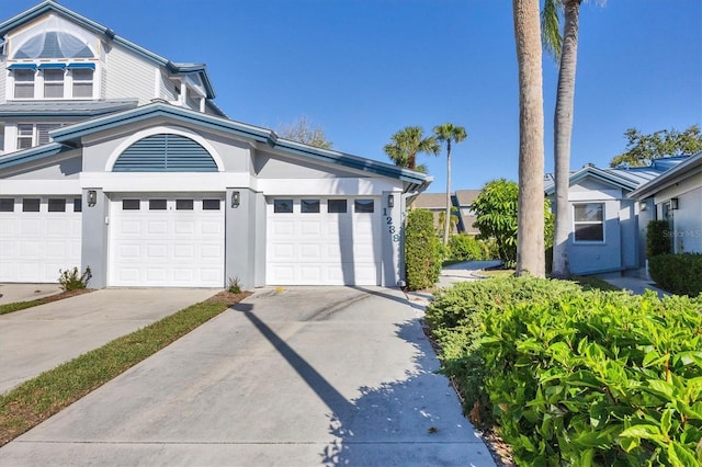 exterior space with stucco siding, driveway, and a garage