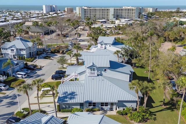 birds eye view of property featuring a city view and a water view