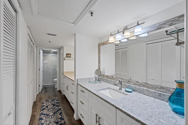 full bathroom with visible vents, a stall shower, wood finished floors, a closet, and vanity