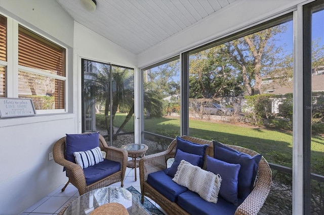 sunroom / solarium featuring vaulted ceiling