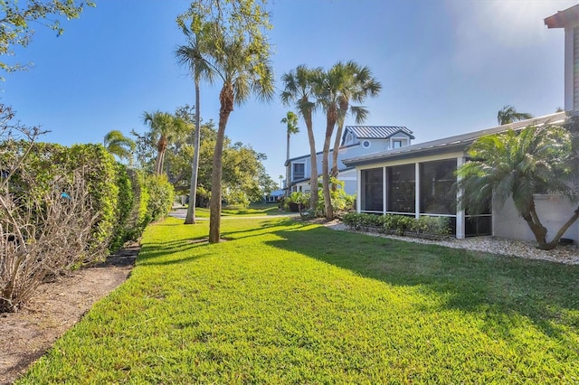 view of yard featuring a sunroom